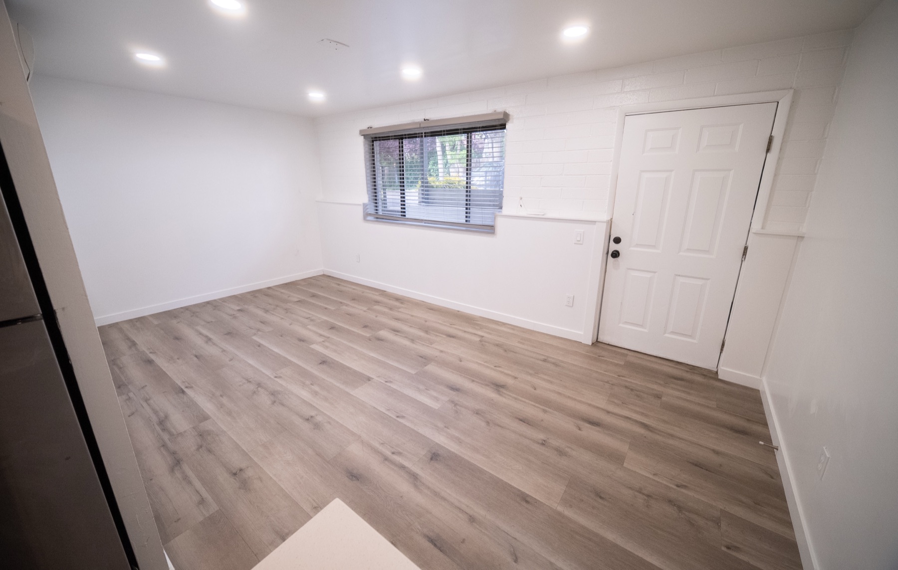 Bedroom with vinyl plank floors, window, and closet