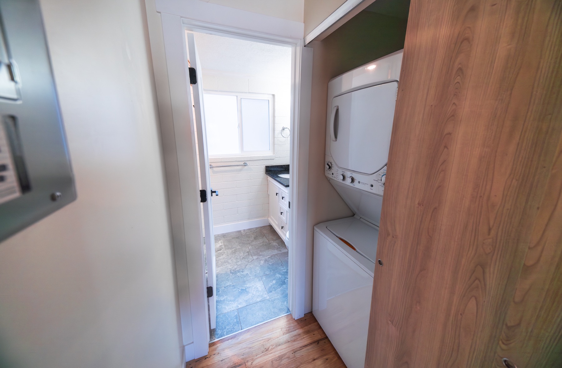 Hallway with in-unit stacked washer and dryer